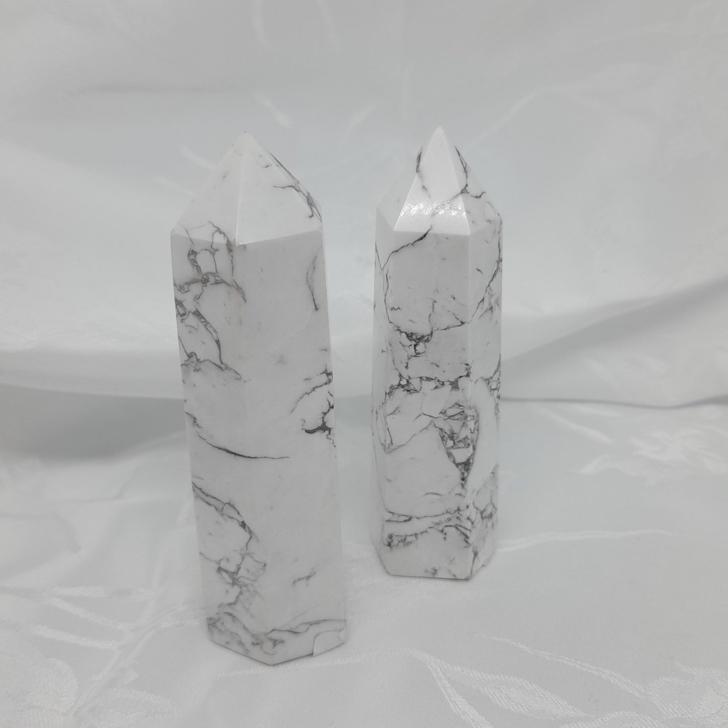 Howlite Point: A powerful white crystal measuring roughly 9cm. Boosts memory, aids concentration, and promotes restful sleep. Unique sizes and markings may vary. Price for one crystal. Invite the transformative energy of Howlite into your life.
