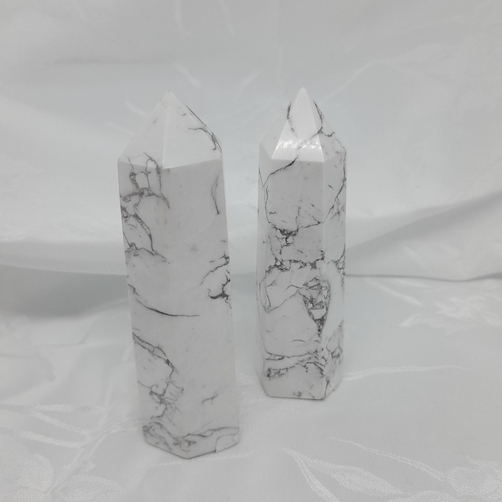Howlite Point: A powerful white crystal measuring roughly 9cm. Boosts memory, aids concentration, and promotes restful sleep. Unique sizes and markings may vary. Price for one crystal. Invite the transformative energy of Howlite into your life.
