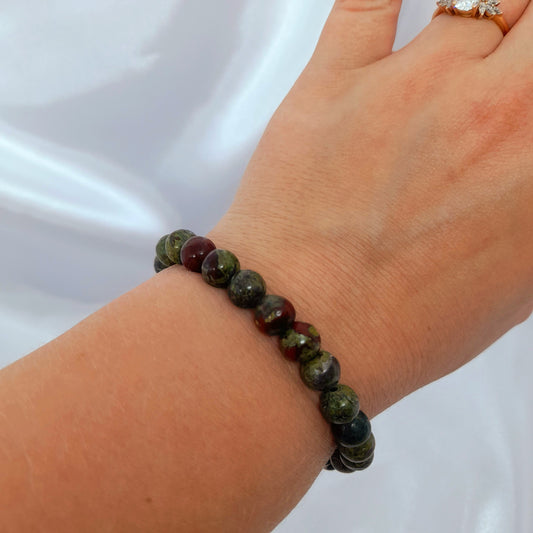 Dragon Blood Crystal Bracelet: A captivating accessory featuring Dragons Blood Jasper, known for goal achievement, attracting wealth and love, and enhancing creativity. This bracelet promotes self-discovery, spiritual realizations, and growth. Specify your size preference for a unique and empowering fit.