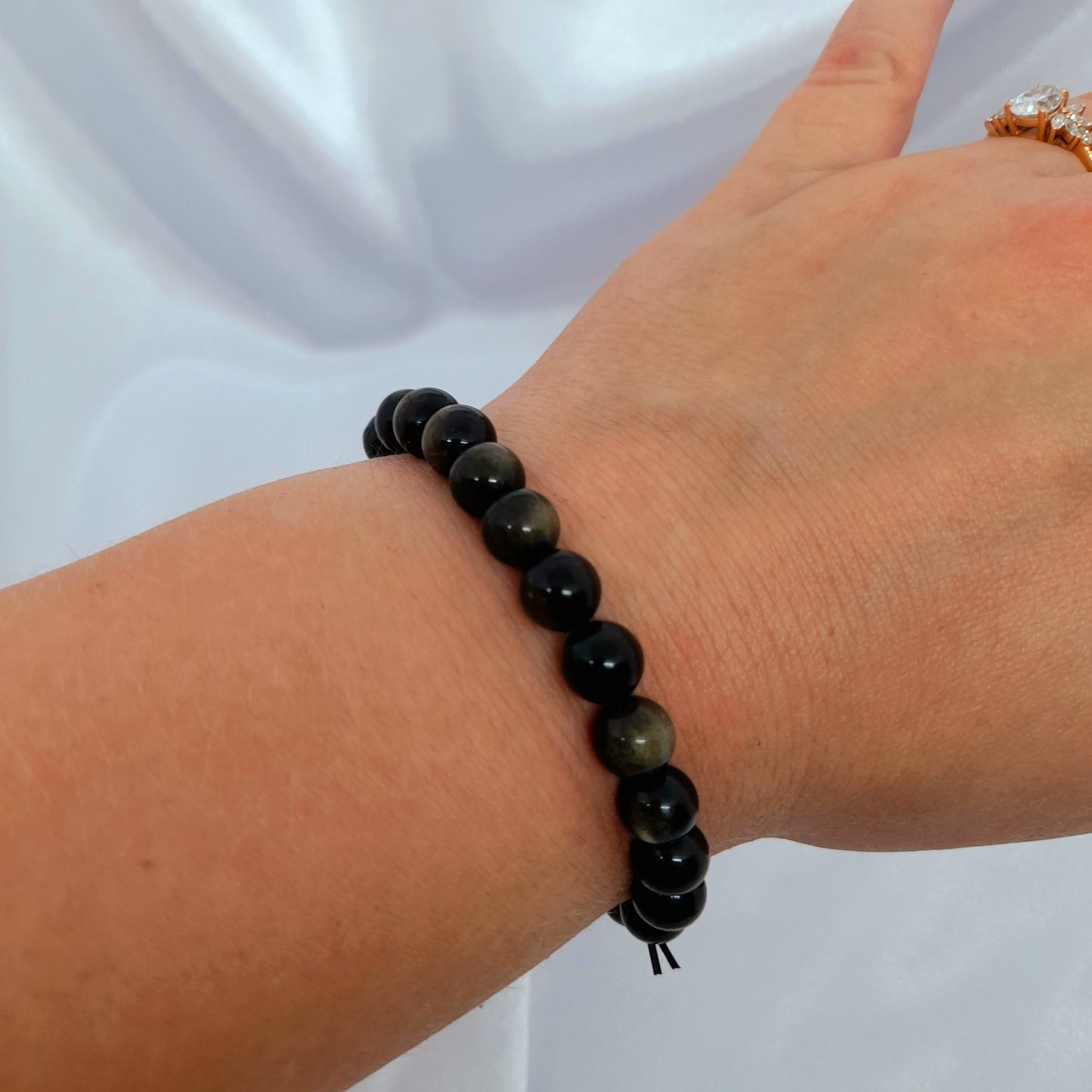 Gold Obsidian Crystal Bracelet: Experience the allure of this rare variation, known for purifying the Aura and addressing ego issues. Each bracelet is a unique creation with variations in tightness. Specify your size preference for a perfect fit. Carry the transformative energy and protective qualities of Gold Obsidian with you in style
