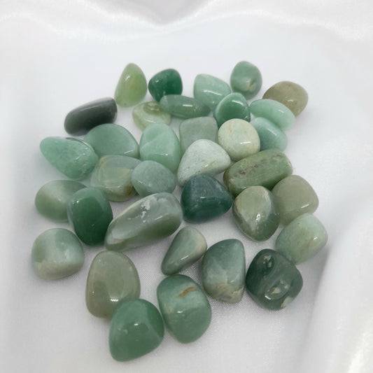 Green Aventurine Mini Tumble: A gorgeous green crystal known for luck, confidence, courage, and wisdom. Invite abundance into your life with this unique and captivating mini tumble. Crystal sizes and markings may vary. Price for one crystal