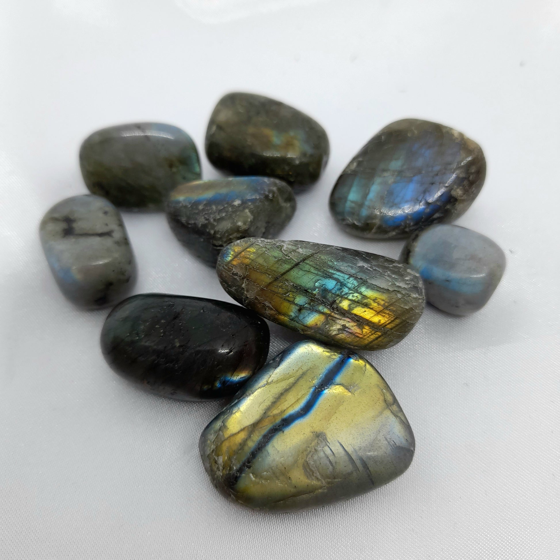 Labradorite Tumble: A powerful stone of protection, aiding in energy restoration and supporting self-healing. Crystal sizes and markings may vary. Price for one crystal. Embrace the unique variations in size and flash, making each Labradorite tumble a captivating addition to your crystal collection.