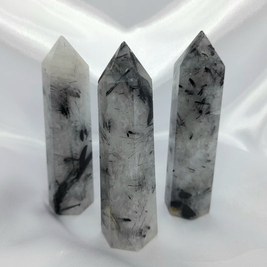 Energizing Tourmaline in Quartz Crystal - Amplify positivity and clear negativity with this stunning 10cm crystal. Each unique piece features varying sizes and markings. Elevate your energy and embrace harmony.