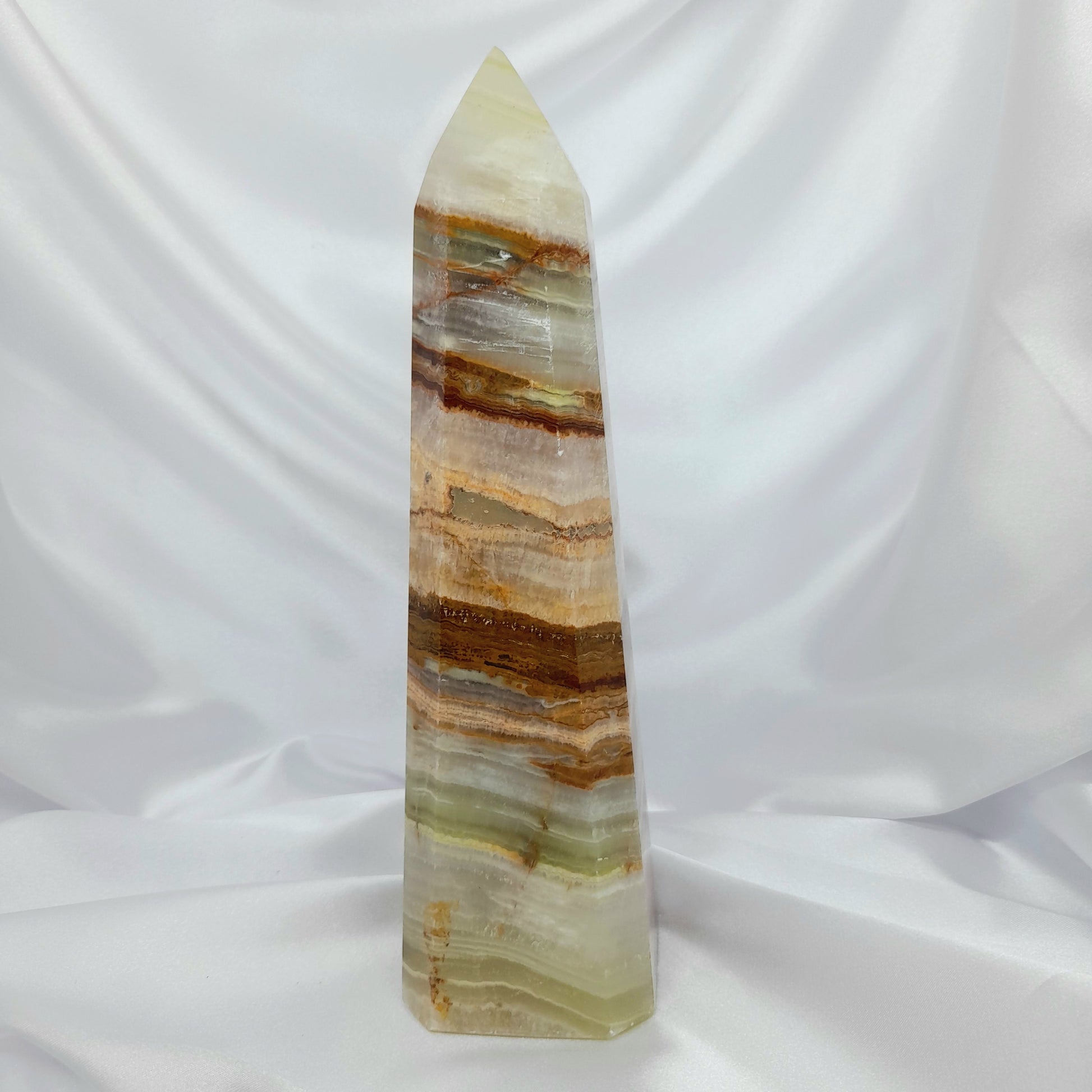 Green Banded Calcite Tower: A powerful crystal, also known as Green Onyx, fostering forgiveness and openness. This transformative gem encourages positive change. Roughly 23cm, 1.374kg. Invite the soothing energy of Green Banded Calcite into your space and embark on a journey of emotional healing and personal transformation."