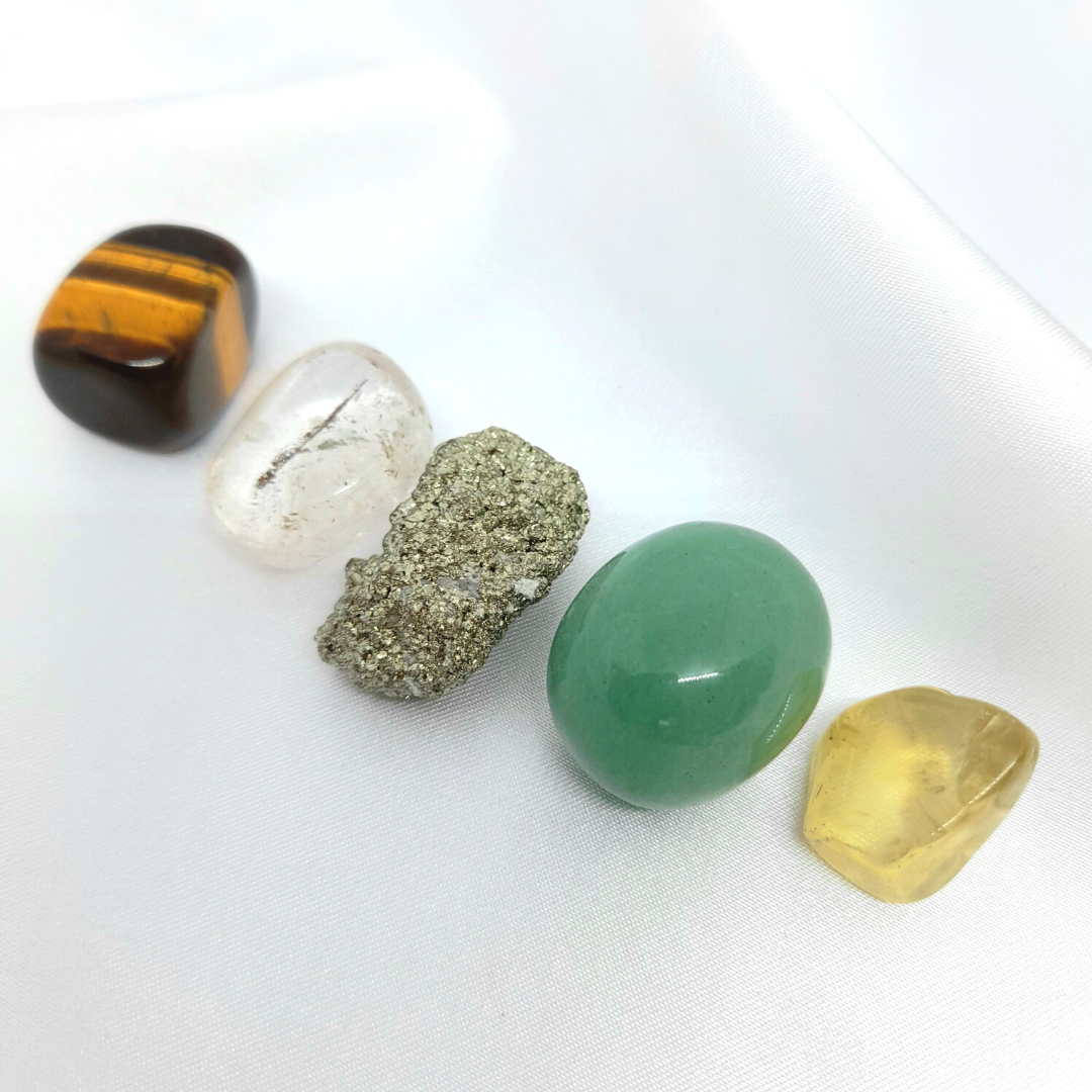 Give Me Luck Bundle: Pyrite, Citrine, Aventurine, Clear Quartz, and Tiger’s Eye crystals. Attract wealth, success, luck, and positive energy. Enhance confidence, mental clarity, and spiritual growth. Embrace the power of these crystals for a fortunate journey. Image shows a variety of crystals in the bundle